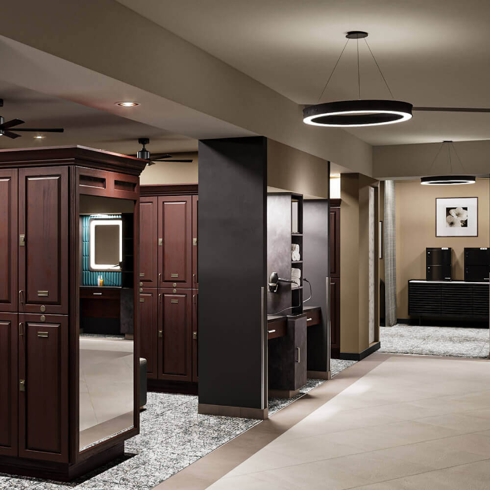 Village Clubs Camelback locker room with dark wood lockers, modern sinks, circular lights, and upscale neutral decor.
