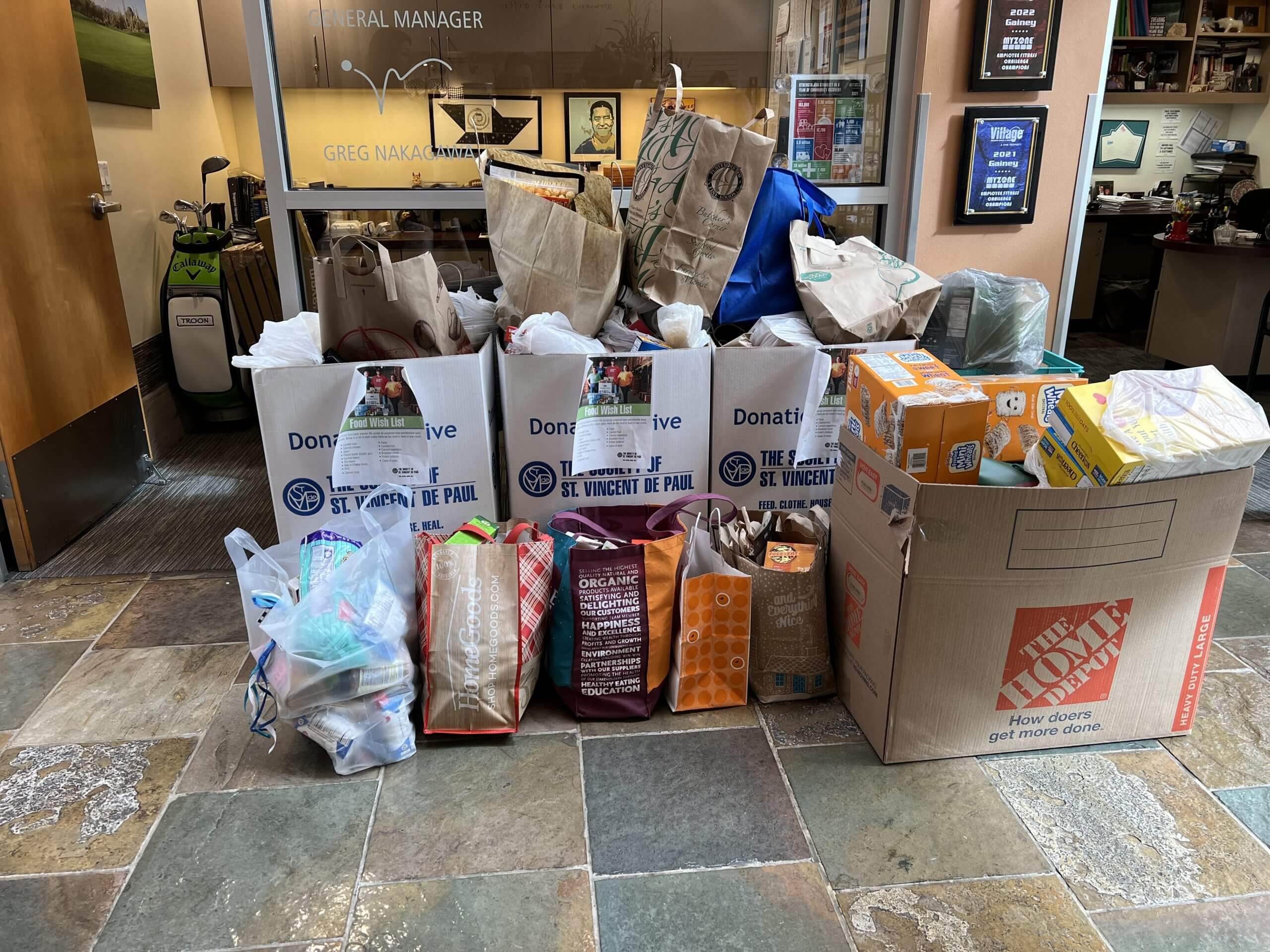 Donated food and household items for St. Vincent de Paul fill the Village Clubs Camelback lobby as part of Village Cares initiative.