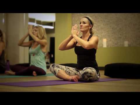 Women participating in a group yoga class at Village Clubs Camelback, emphasizing wellness and community in Arizona.