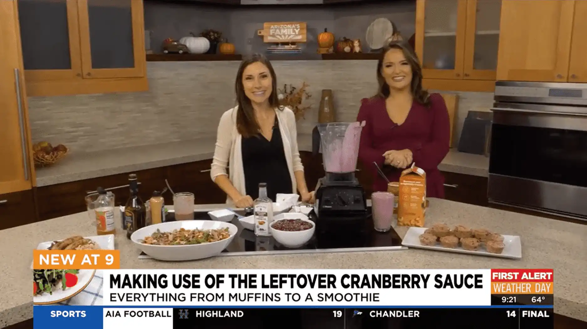 Two women at Village Clubs Camelback kitchen smile while making food, drinks, and cranberry recipes with muffins and smoothies.